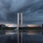 Edifício da Caesb em Brasília com bandeira a meio mastro, simbolizando luto pela morte de advogado na diretoria jurídica.